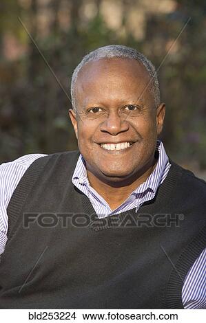 Picture - Portrait of African American man smiling outdoors. Fotosearch