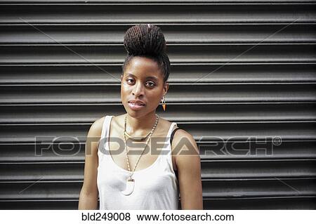Portrait of African American woman with braids near metal wall View Large Photo Image Stock Photo - Portrait of African American woman with braids near metal wall. Fotosearch