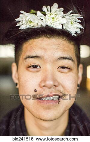 Portrait of androgynous Asian man with flowers in hair View Large Photo Image Stock Photograph - Portrait of androgynous Asian man with flowers in hair. Fotosearch