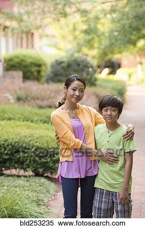 Portrait of Asian mother and son standing on sidewalk View Large Photo Image Stock Photography - Portrait of Asian mother and son standing on sidewalk. Fotosearch