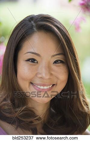 Portrait of Asian woman smiling outdoors View Large Photo Image Stock Photo - Portrait of Asian woman smiling outdoors. Fotosearch