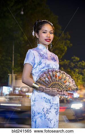 Portrait of Asian woman wearing traditional clothing holding fan View Large Photo Image Stock Photography - Portrait of Asian woman wearing traditional clothing holding fan. Fotosearch