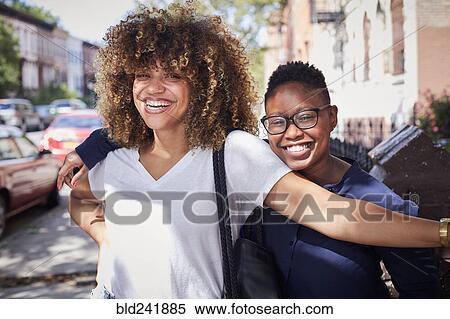 Portrait of Black women hugging on city sidewalk View Large Photo Image Stock Photography - Portrait of Black women hugging on city sidewalk. Fotosearch