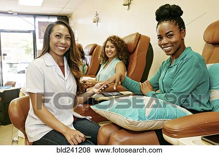 Portrait of business owner and customers in nail salon View Large Photo Image Stock Photo - Portrait of business owner and customers in nail salon. Fotosearch
