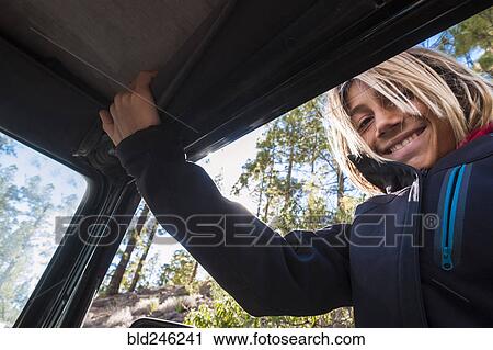 Stock Image - Portrait of Caucasian boy in car window. Fotosearch