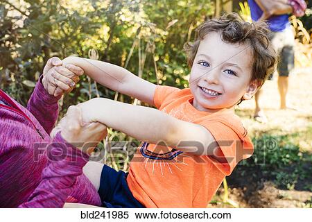 Stock Photography - Portrait of Caucasian boy playing with mother. Fotosearch