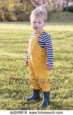 Stock Photo - Portrait of Caucasian boy standing in field. Fotosearch