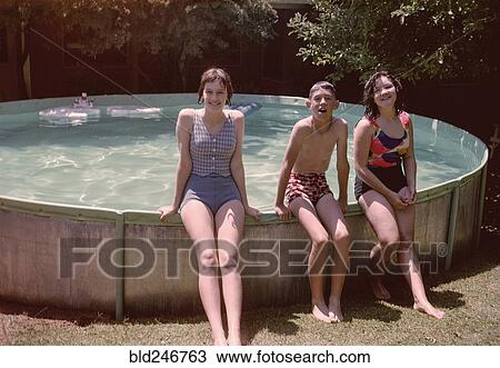 Portrait of Caucasian brother and sisters leaning on swimming pool View Large Photo Image Stock Image - Portrait of Caucasian brother and sisters leaning on swimming pool. Fotosearch