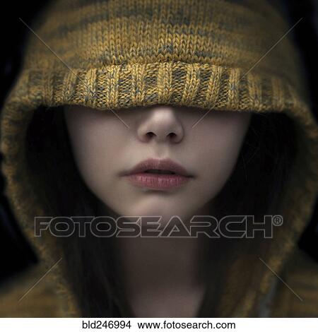 Picture - Portrait of Caucasian girl covering eyes with hood. Fotosearch