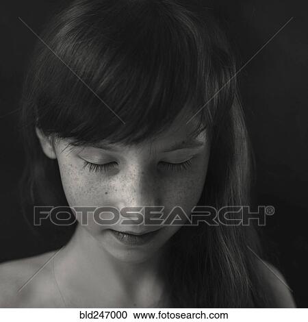 Stock Image - Portrait of Caucasian girl looking down. Fotosearch