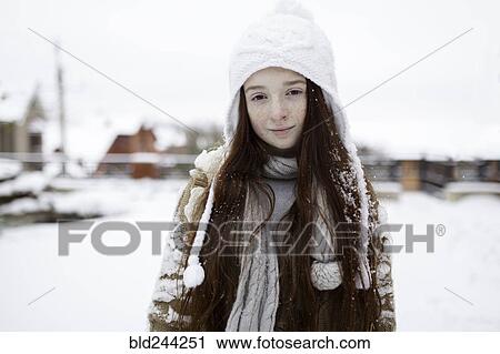 Stock Image - Portrait of Caucasian girl outdoors in snow. Fotosearch