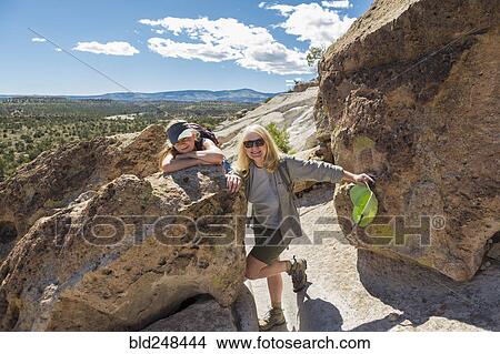 Portrait of Caucasian grandmother and granddaughter leaning on rock View Large Photo Image Picture - Portrait of Caucasian grandmother and granddaughter leaning on rock. Fotosearch