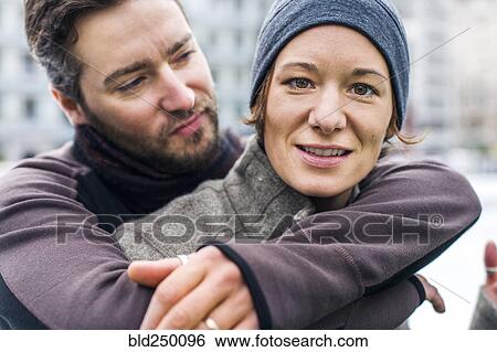 Stock Photograph - Portrait of Caucasian man hugging woman. Fotosearch