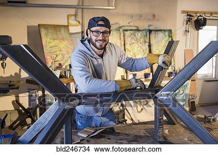 Portrait of Caucasian man leaning on metal sculpture View Large Photo Image Picture - Portrait of Caucasian man leaning on metal sculpture. Fotosearch