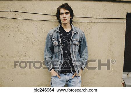 Portrait of Caucasian man leaning on wall View Large Photo Image Picture - Portrait of Caucasian man leaning on wall. Fotosearch