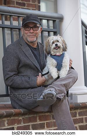 Portrait of Caucasian man sitting on stoop posing with dog View Large Photo Image Stock Photography - Portrait of Caucasian man sitting on stoop posing with dog. Fotosearch