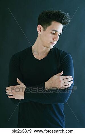 Stock Photo - Portrait of Caucasian man with arms crossed. Fotosearch
