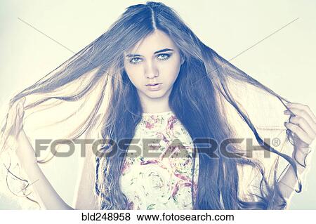 Stock Photo - Portrait of Caucasian teenage girl pulling hair. Fotosearch
