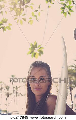 Portrait of Caucasian woman holding surfboard View Large Photo Image Stock Photo - Portrait of Caucasian woman holding surfboard. Fotosearch