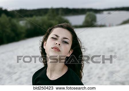 Stock Image - Portrait of Caucasian woman making a face. Fotosearch