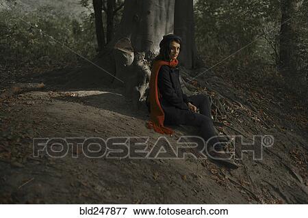 Portrait of Caucasian woman sitting on tree roots in forest View Large Photo Image Stock Photo - Portrait of Caucasian woman sitting on tree roots in forest. Fotosearch