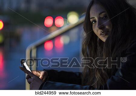 Portrait of Caucasian woman texting on cell phone outdoors View Large Photo Image Stock Photo - Portrait of Caucasian woman texting on cell phone outdoors. Fotosearch