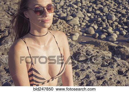 Portrait of Caucasian woman wearing sunglasses and bikini View Large Photo Image Stock Image - Portrait of Caucasian woman wearing sunglasses and bikini. Fotosearch