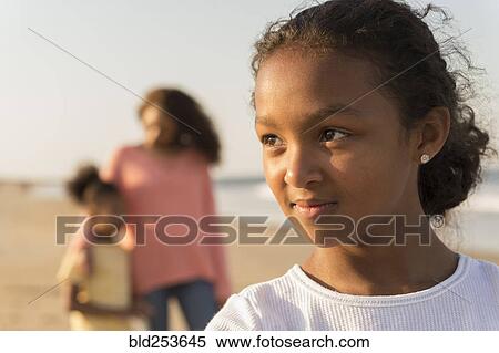 Stock Photography - Portrait of confident girl at beach. Fotosearch
