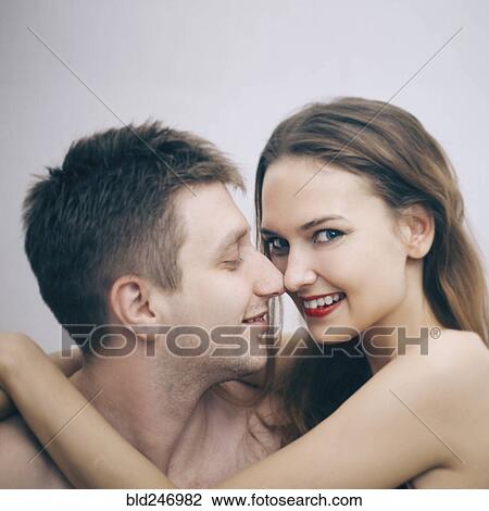 Stock Image - Portrait of cuddling Caucasian couple. Fotosearch