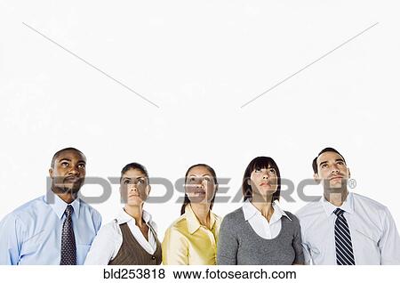Stock Photo - Portrait of curious business people looking up. Fotosearch