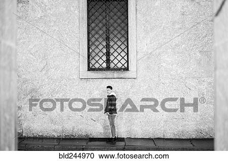 Portrait of distant man standing underneath window on sidewalk View Large Photo Image Stock Image - Portrait of distant man standing underneath window on sidewalk. Fotosearch