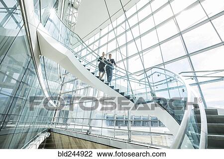 Portrait of distant Mixed Race business people standing on staircase View Large Photo Image Stock Image - Portrait of distant Mixed Race business people standing on staircase. Fotosearch