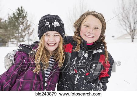 Portrait of girls hugging in winter View Large Photo Image Stock Photo - Portrait of girls hugging in winter. Fotosearch