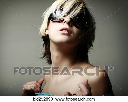 Stock Image - Portrait of glamorous Caucasian teenage girl wearing sunglasses. Fotosearch