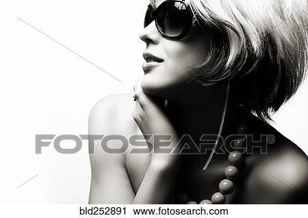 Stock Image - Portrait of glamorous Caucasian teenage girl wearing sunglasses. Fotosearch