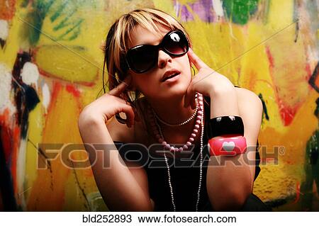 Stock Image - Portrait of glamorous Caucasian teenage girl wearing sunglasses. Fotosearch