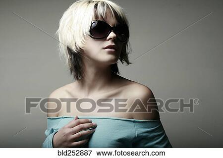 Stock Photo - Portrait of glamorous Caucasian teenage girl wearing sunglasses. Fotosearch
