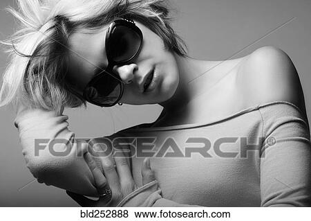 Stock Photo - Portrait of glamorous Caucasian teenage girl wearing sunglasses. Fotosearch