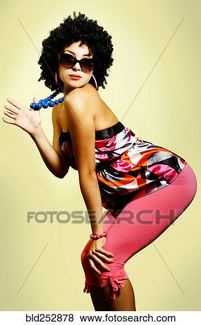 Stock Photo - Portrait of glamorous woman wearing sunglasses couching. Fotosearch