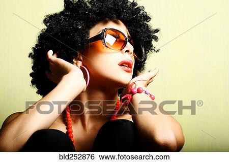 Stock Photograph - Portrait of glamorous woman wearing sunglasses. Fotosearch
