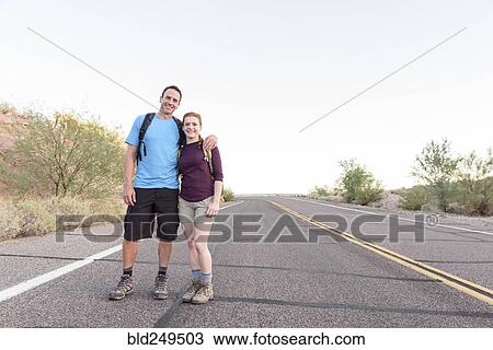 Stock Image - Portrait of hikers posing in street. Fotosearch