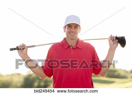Picture - Portrait of Hispanic golfer holding golf club on shoulders. Fotosearch