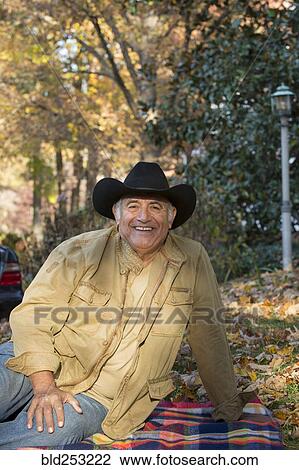 Portrait of Hispanic man sitting on blanket outdoors View Large Photo Image Stock Image - Portrait of Hispanic man sitting on blanket outdoors. Fotosearch
