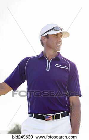 Stock Image - Portrait of Hispanic man wearing American flag belt buckle. Fotosearch