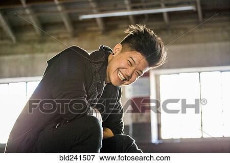 Portrait of laughing androgynous Asian man View Large Photo Image Stock Photo - Portrait of laughing androgynous Asian man. Fotosearch
