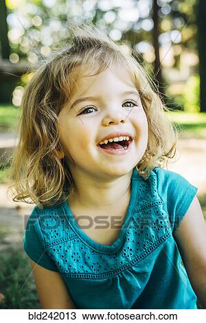 Stock Image - Portrait of laughing Caucasian preschool girl. Fotosearch