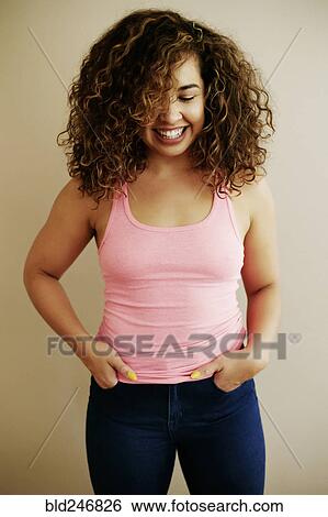 Stock Photograph - Portrait of laughing Mixed Race woman. Fotosearch