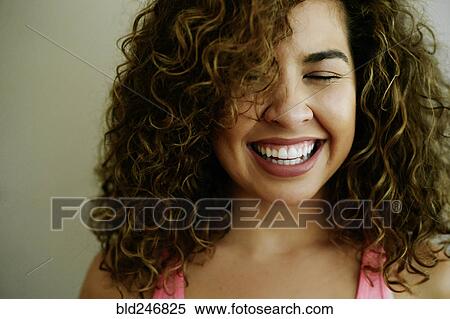 Stock Photography - Portrait of laughing Mixed Race woman. Fotosearch