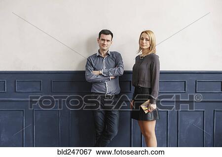 Stock Photo - Portrait of Middle Eastern couple standing near wall. Fotosearch