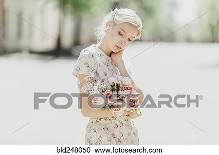 Portrait of Middle Eastern woman holding bouquet View Large Photo Image Stock Image - Portrait of Middle Eastern woman holding bouquet. Fotosearch